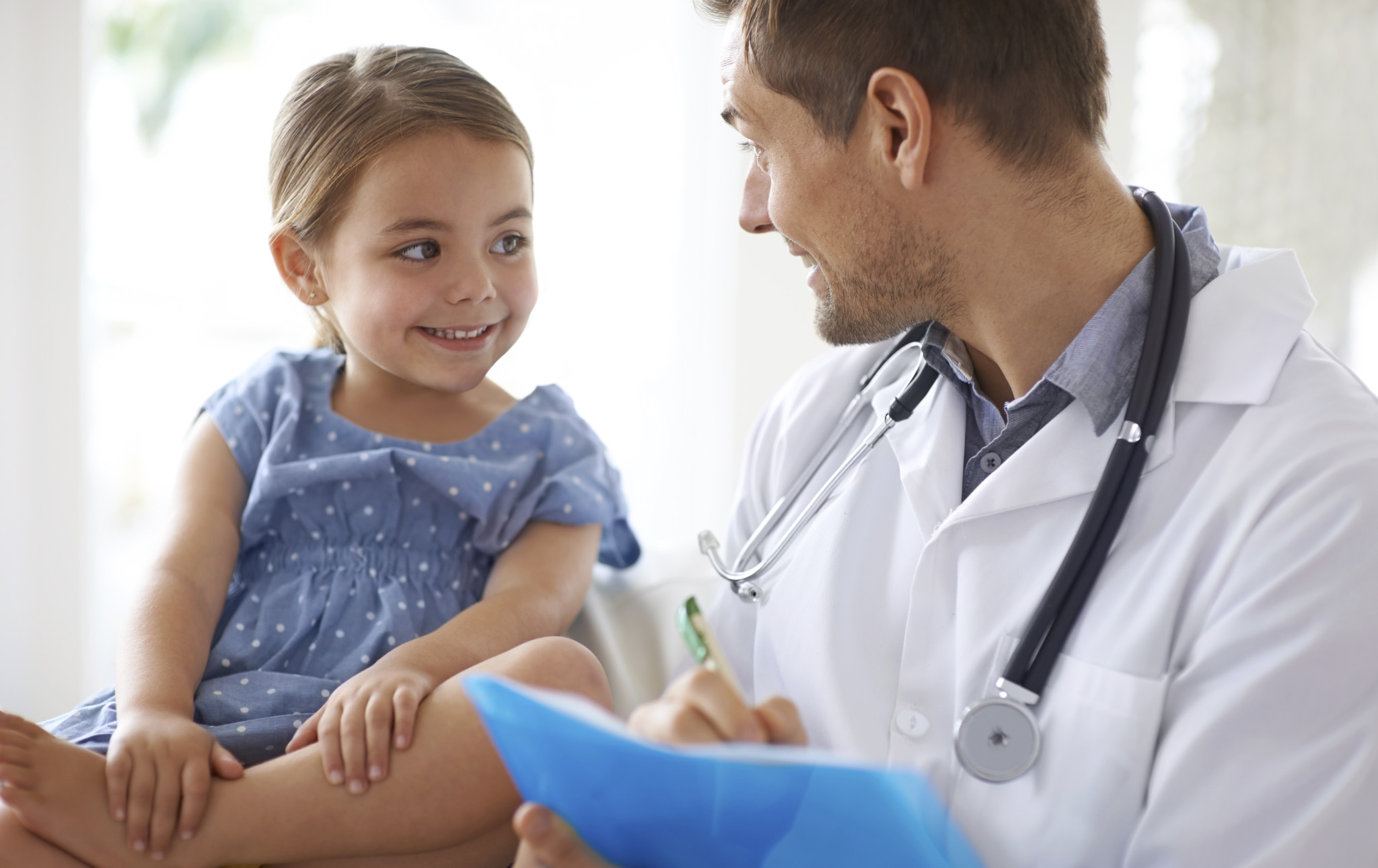 Shot of a handsome male doctor with an adorable young girl for a patient